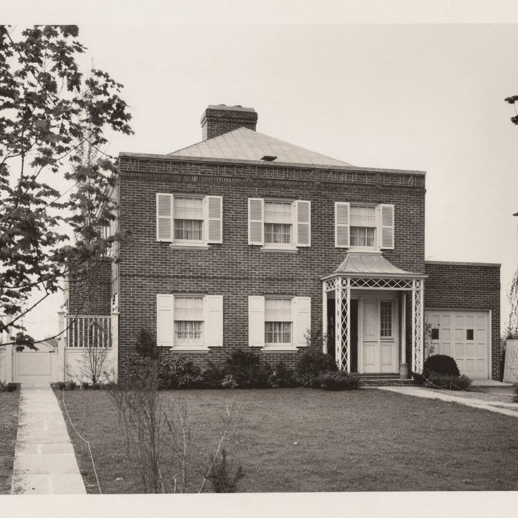 Black and white photograph of a brick house.