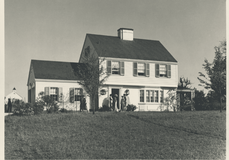 Black and white photo of a white model house.