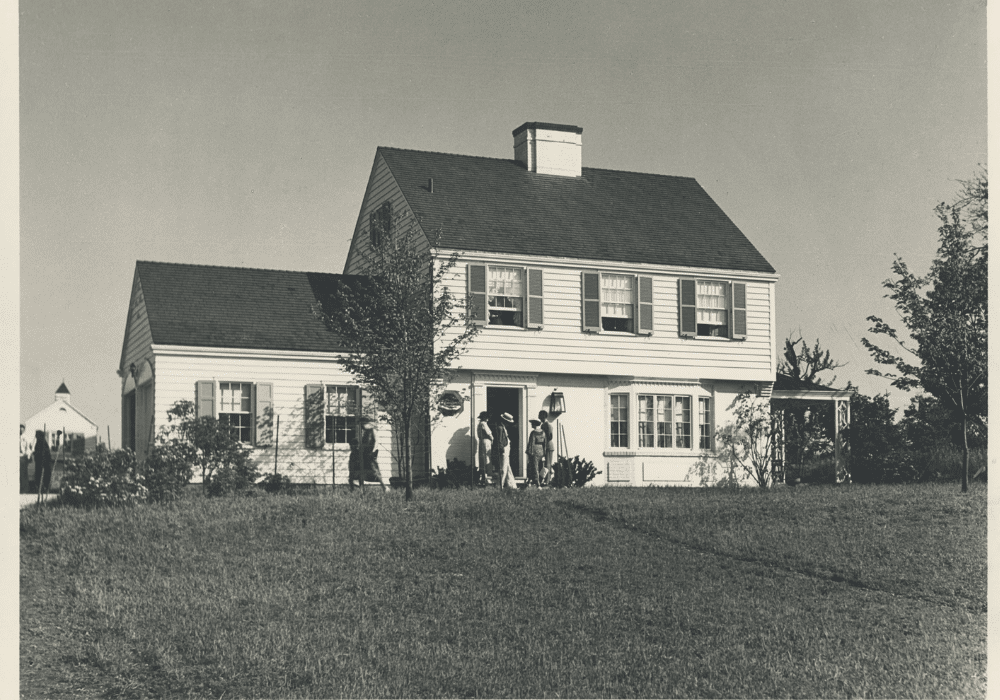 Black and white photo of a white model house.