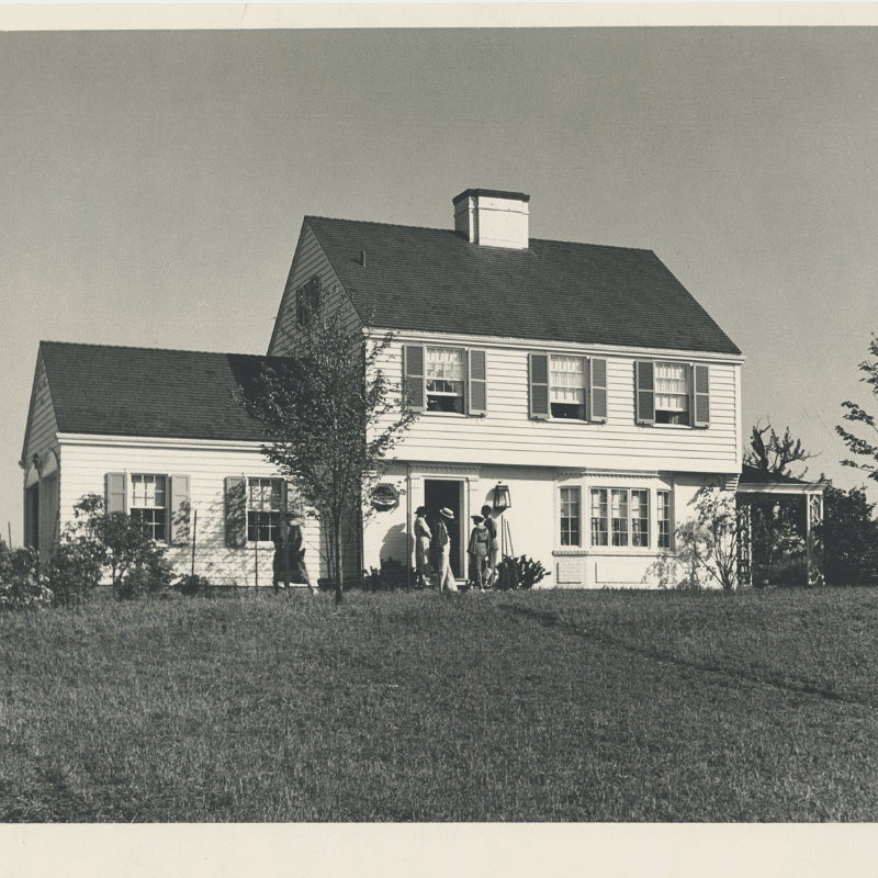 Black and white photo of a white model house.