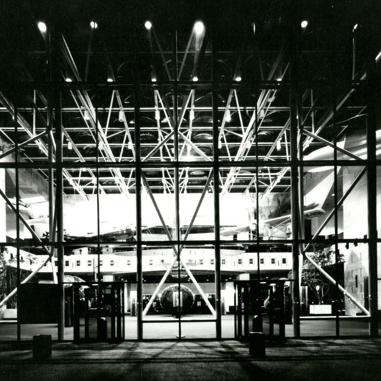 Black and white photograph of the National Air and Space Museum at night with the Apollo 11 Lunar Module